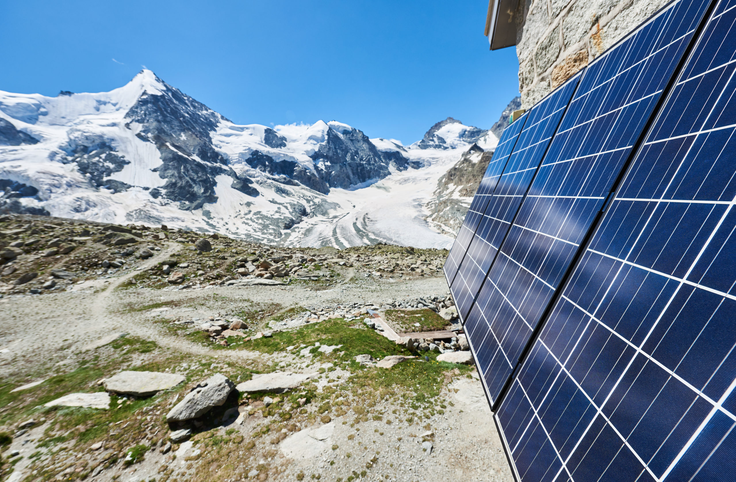 Close-up perspective snapshot of solar modules installed on the walls of alpine hut in Swiss Alps as alternative source of energy, concept of green ecology